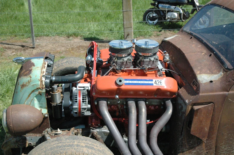 an old orange and black machine with a large engine