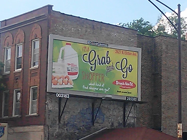a large advertit hangs on a brick building