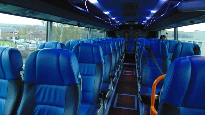 inside view of empty bus with blue chairs