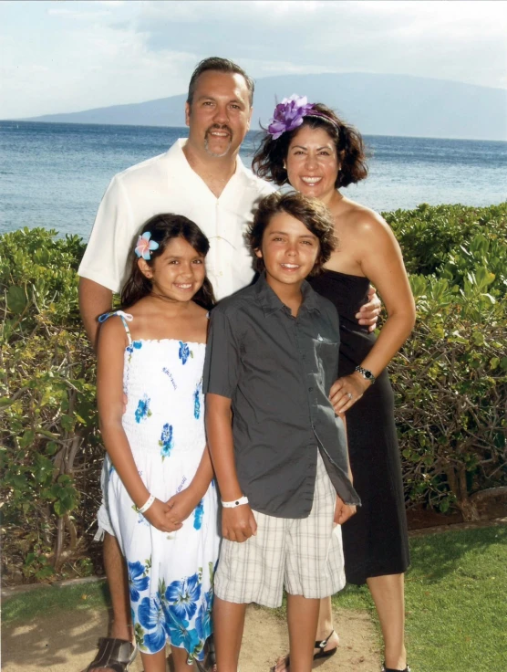 a family taking in the picture on the beach