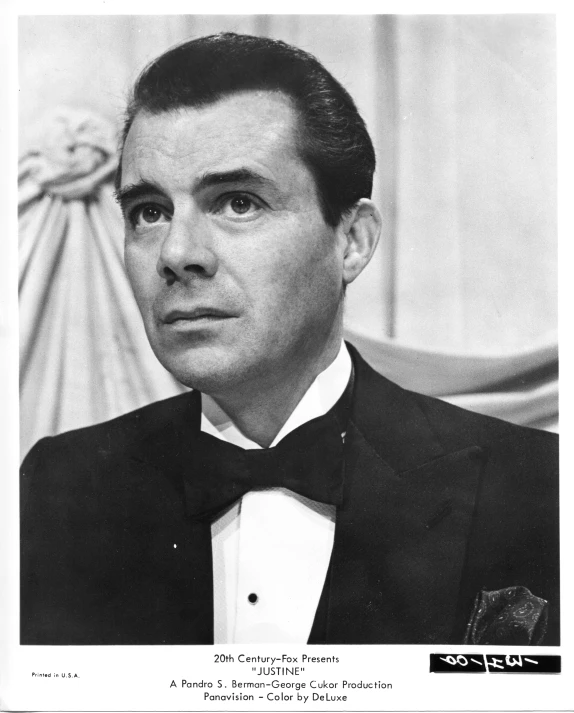 an old po of a man in a tuxedo and bow tie