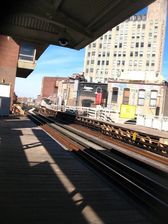 view from a train station with high rise buildings in the background