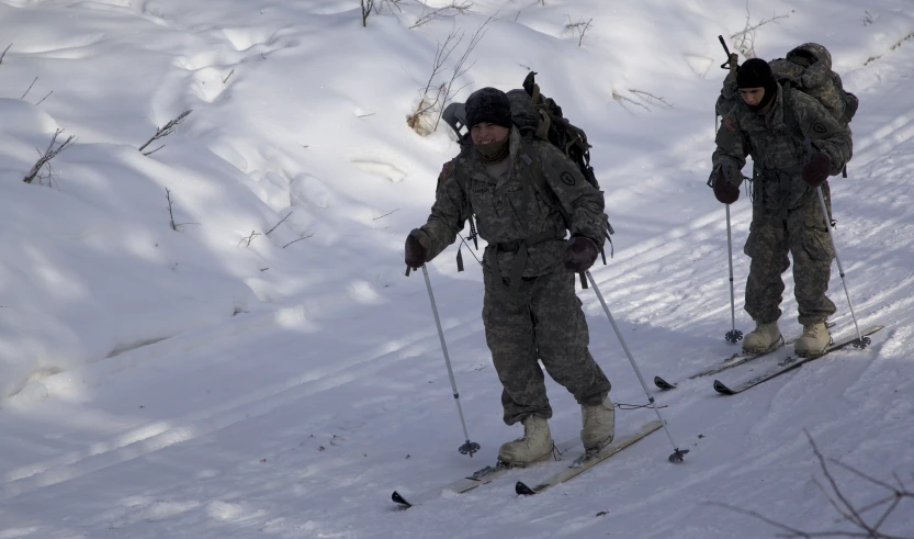 three men skiing in the snow on the ski slope