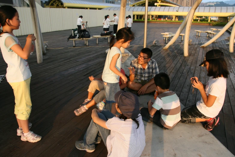 a group of s sitting on top of a wooden pier