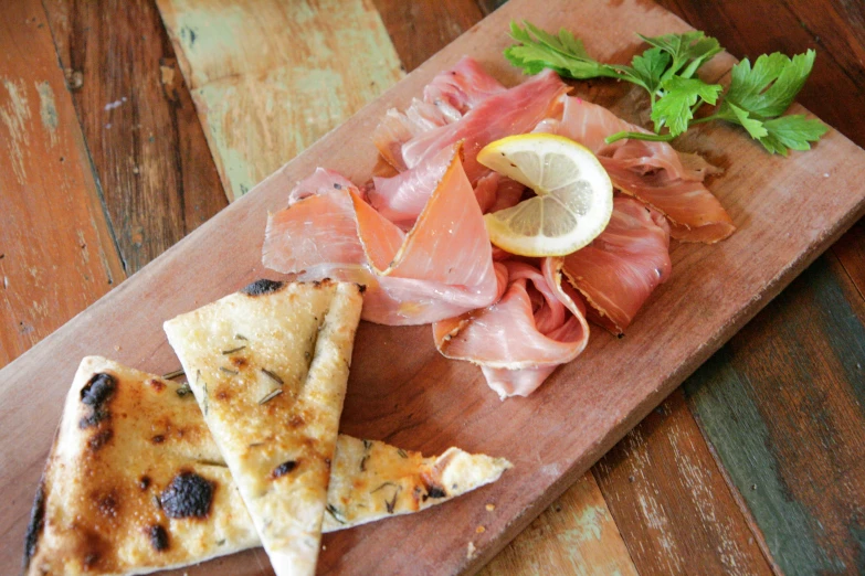 small pieces of food are placed on a small wooden board