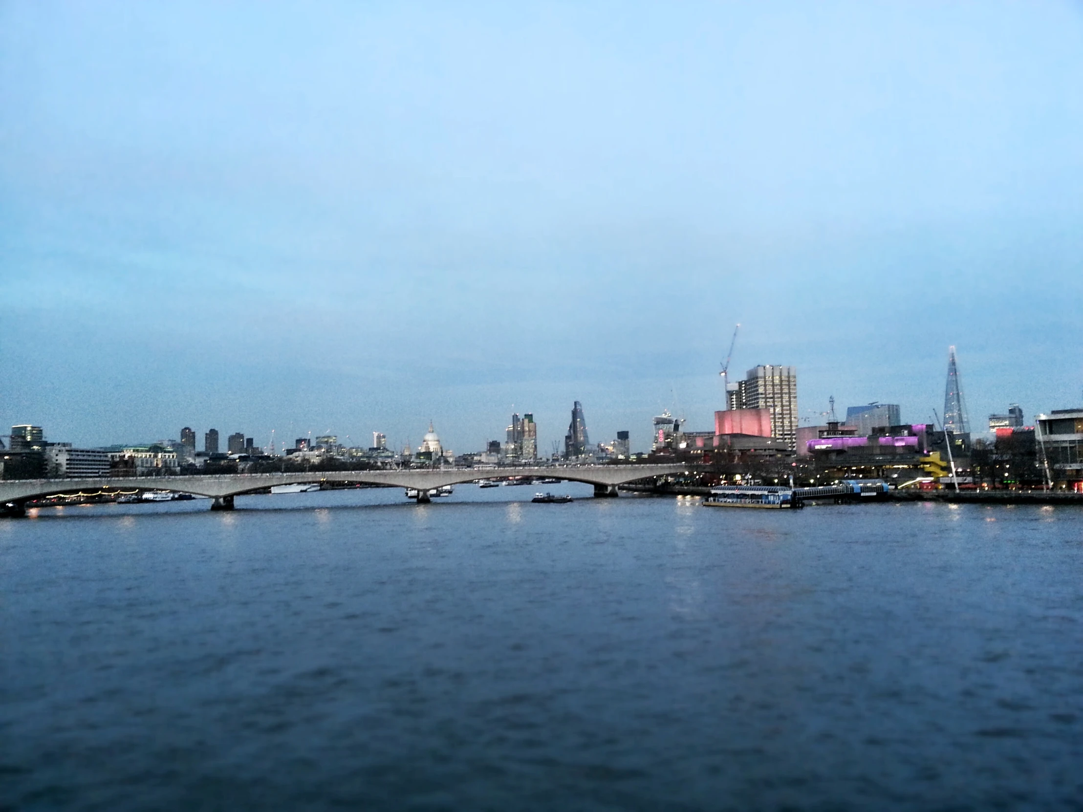 view of the skyline over the water with tall buildings