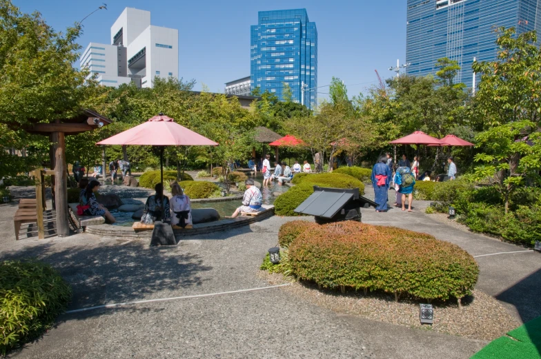 a lot of people sitting on the ground at a park