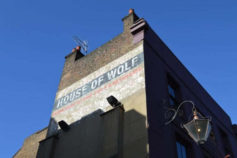 a large, old advertit sign on the side of a building