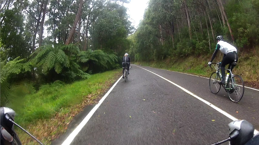 some people are riding bikes in the rain