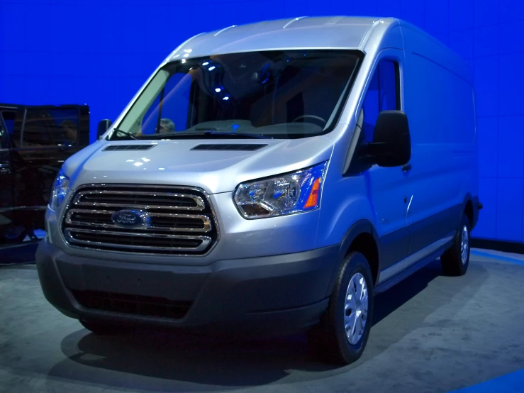 a silver van with its door open in a blue room