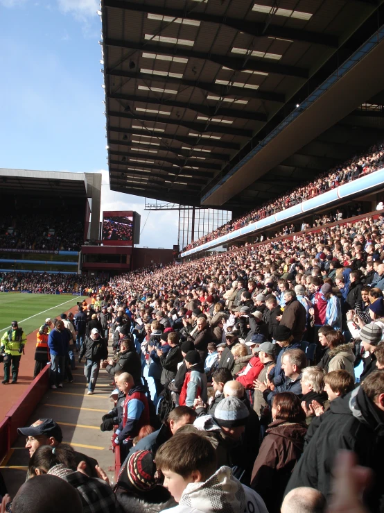 a crowd of people are gathered outside of an stadium