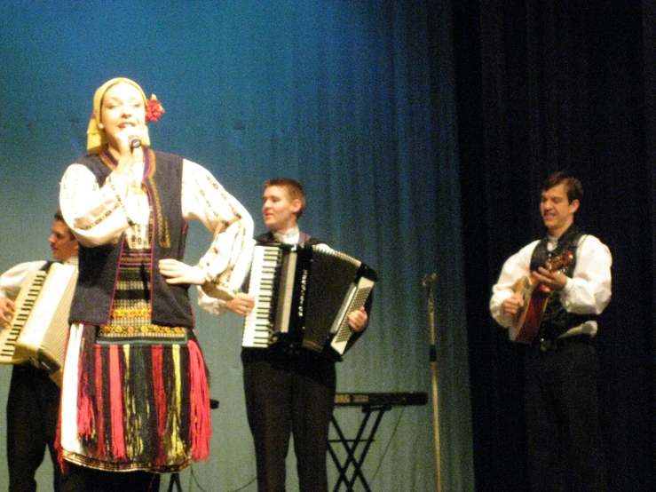 two women and a man in traditional costumes