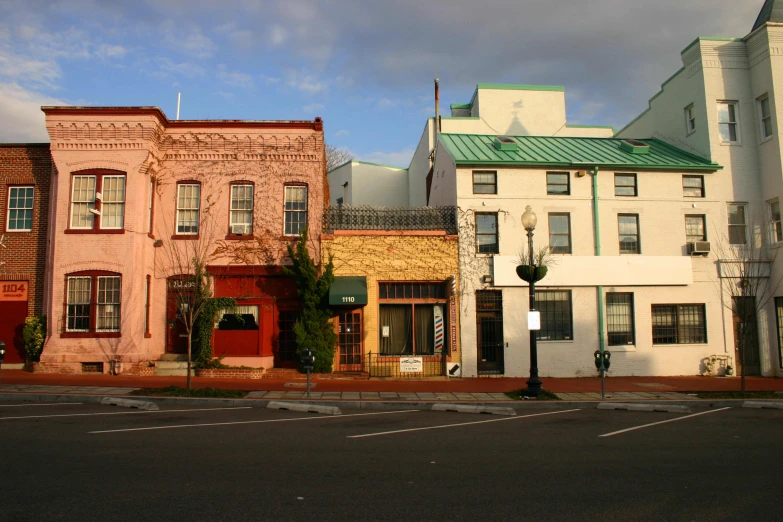 four town buildings sitting side by side on a street