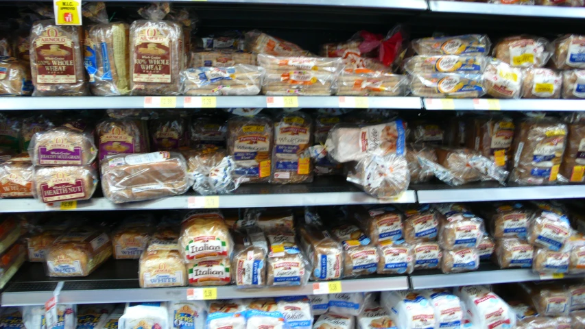 an assortment of bread on display in a grocery store