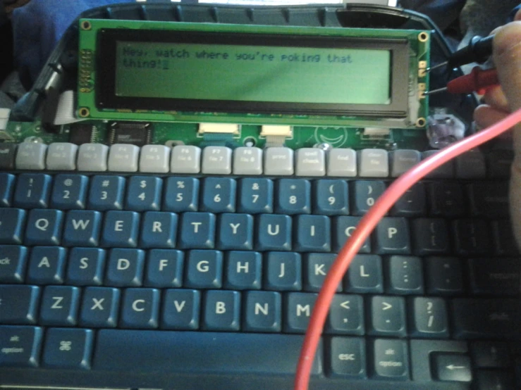 the small electronic computer is attached to a computer keyboard