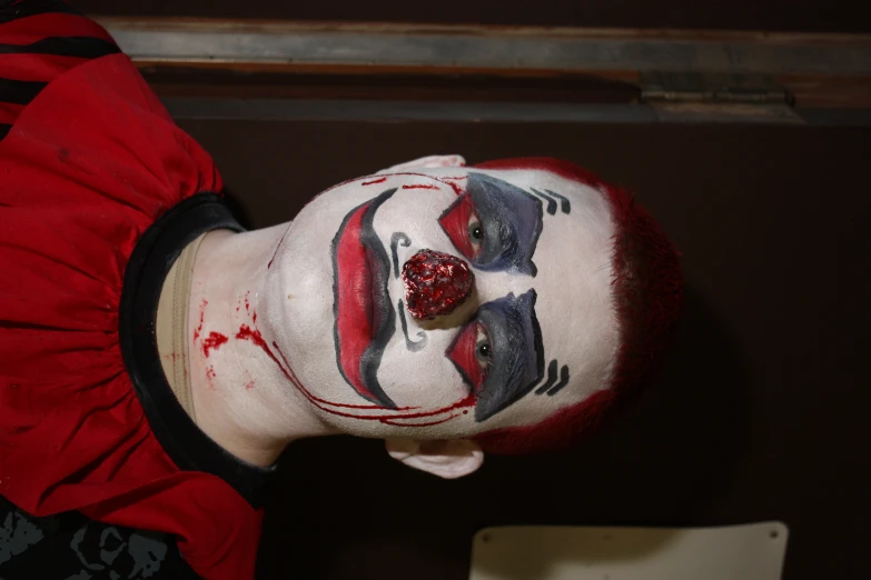 a child with a clown makeup on his face