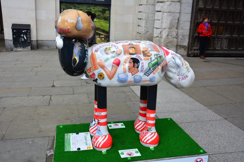 a very large fake animal has been placed in front of the building