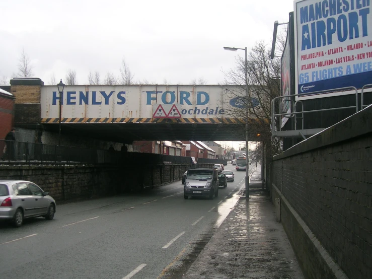 an overpass with a sign on it, which reads henly's ford
