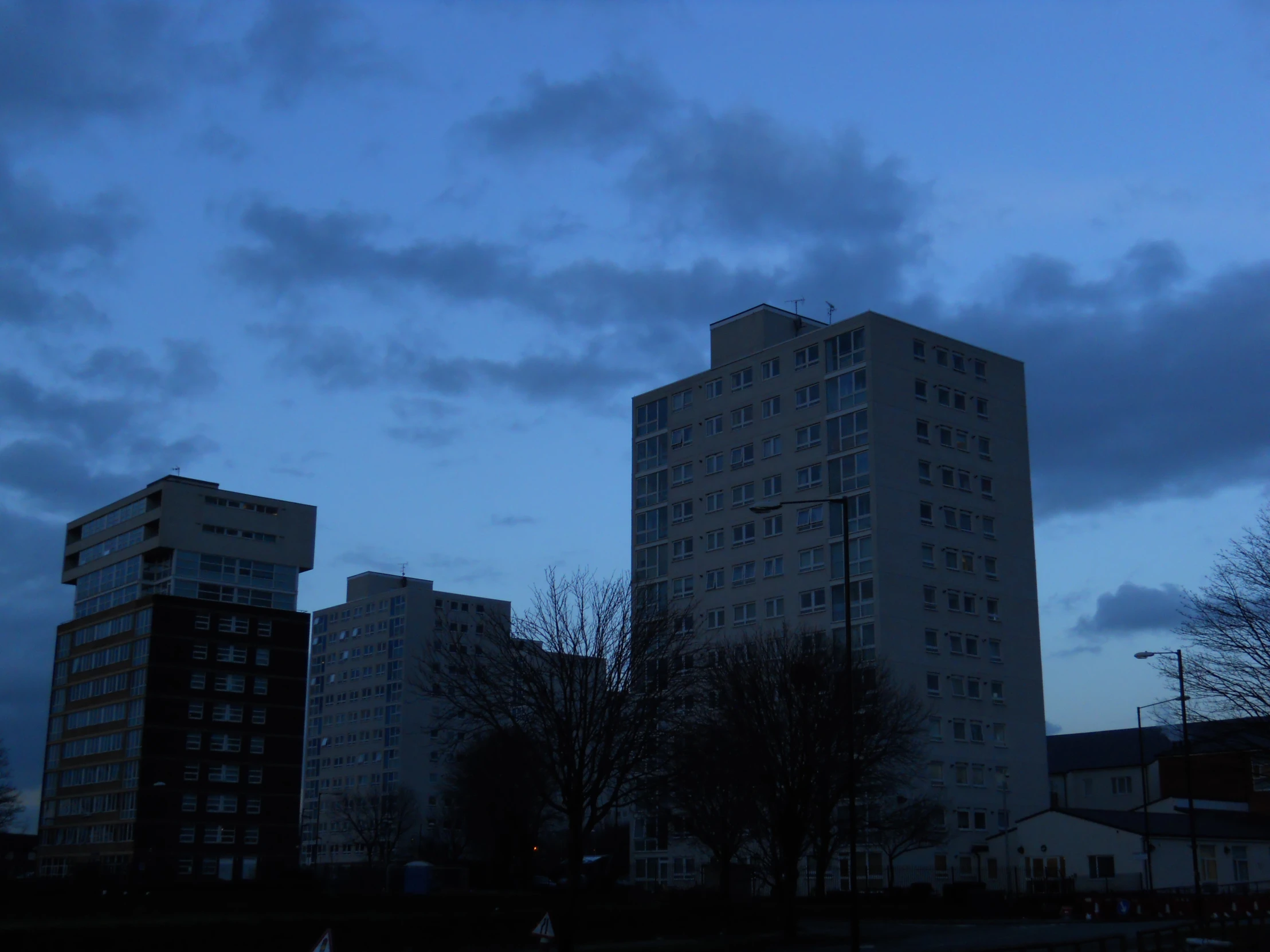 some large tall white buildings in the dark