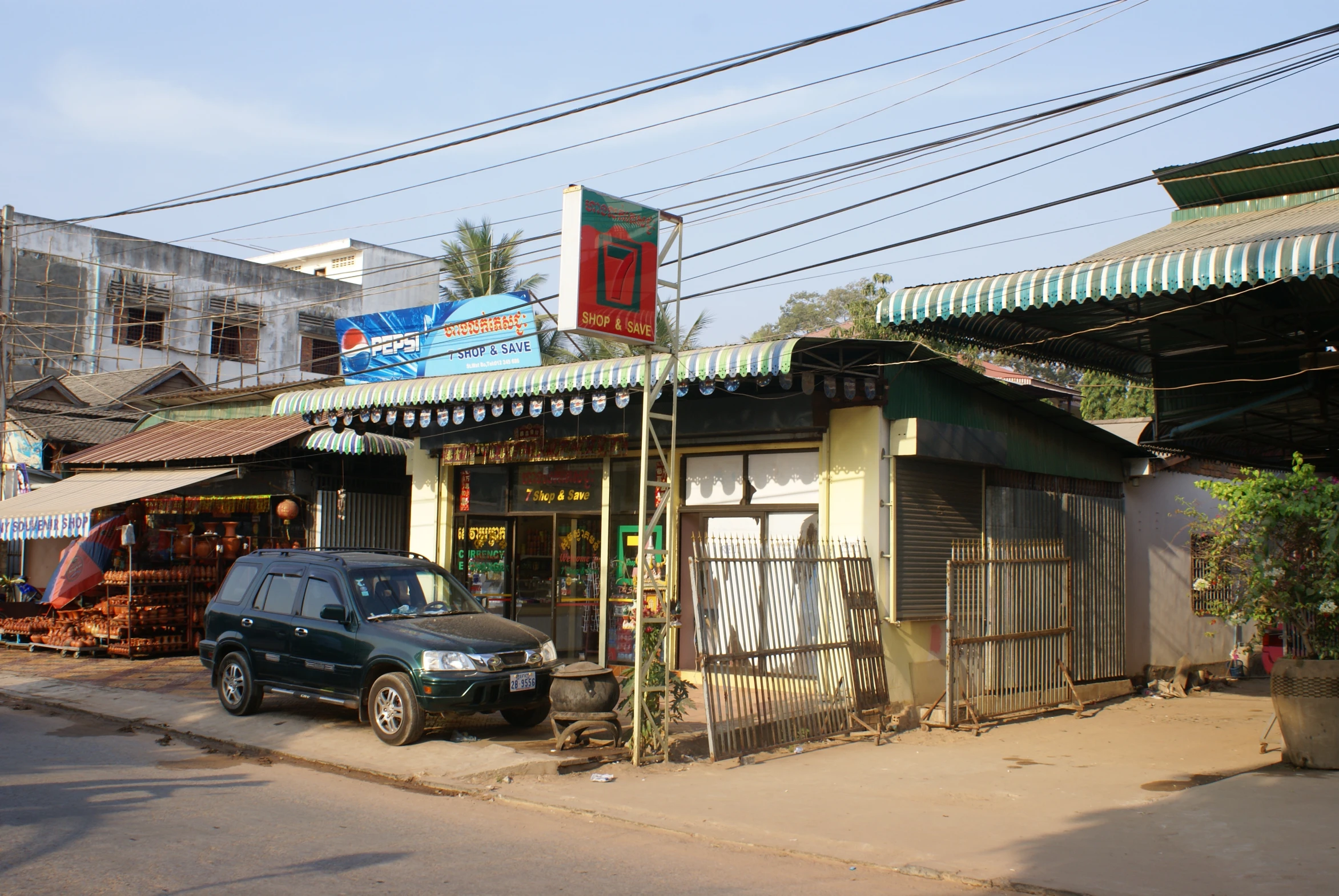 the green van is parked in front of the store