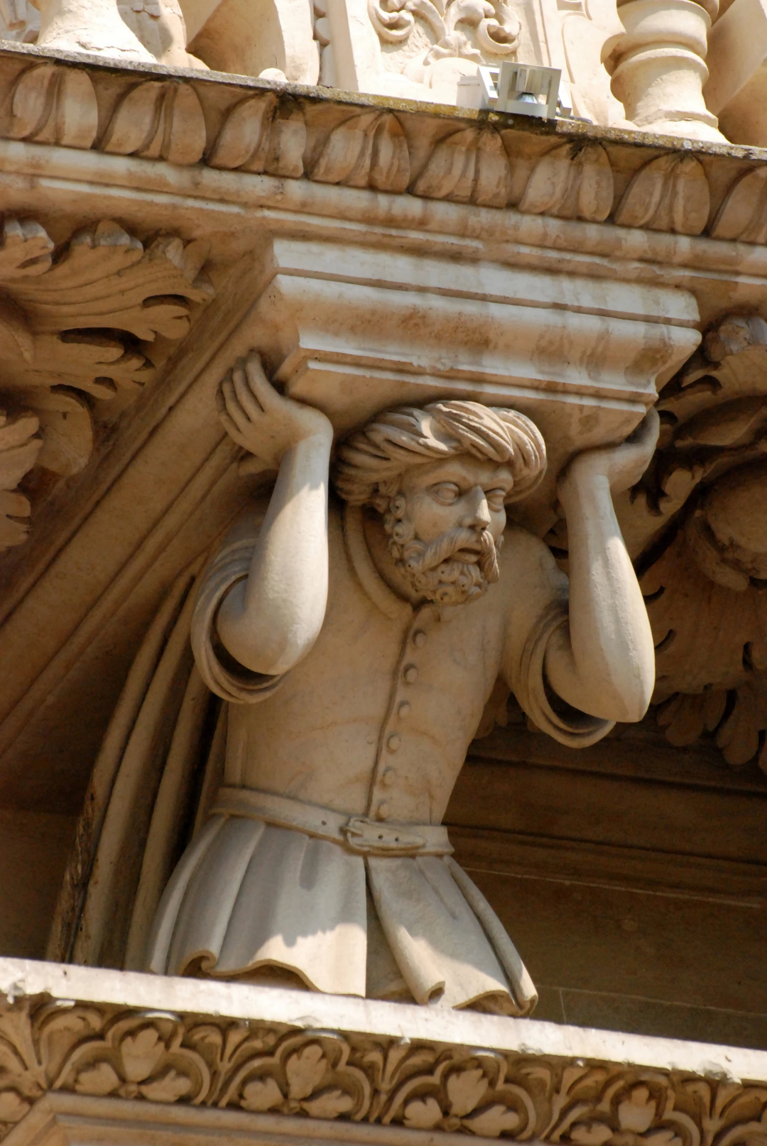 a close up of a stone statue near the building