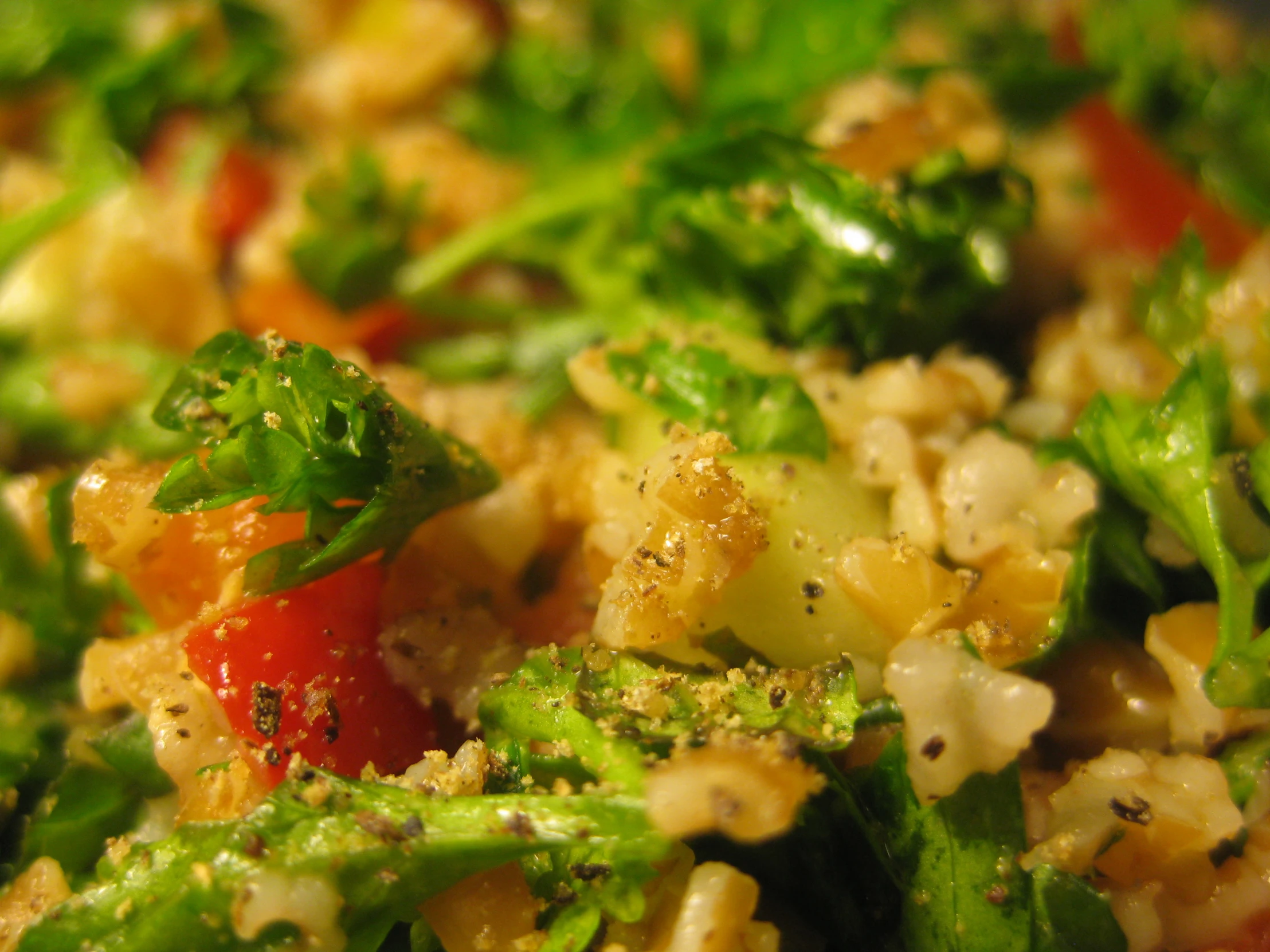 vegetables and grains with seasoning sit mixed together