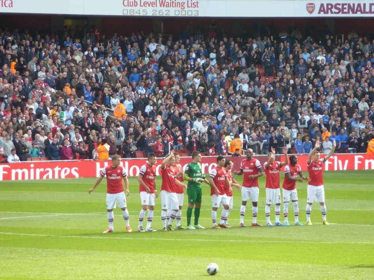 some soccer players standing in front of an audience