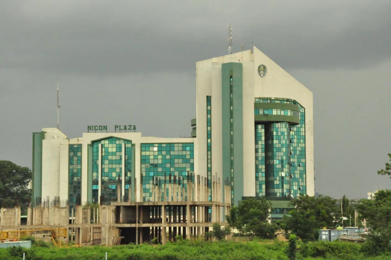 a large building next to the highway under dark skies