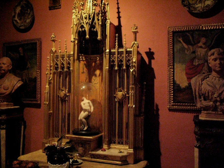 a table with a vase and other sculptures on display