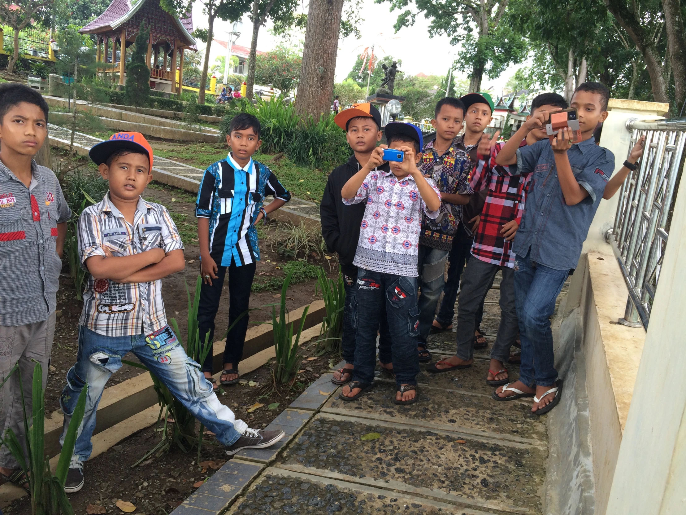 a group of boys standing on a ledge