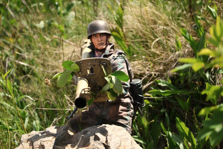 a man with a helmet holding a rifle