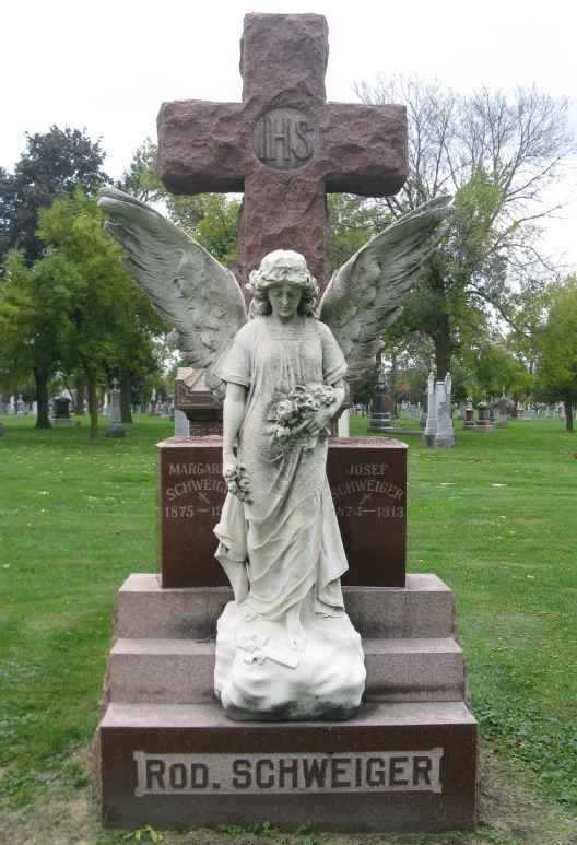 a monument with an angel sitting on top of it