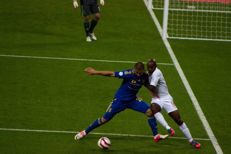 two players fighting for the ball on a soccer field