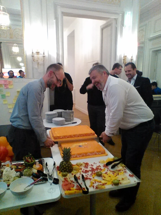 the man are preparing the big table of cake