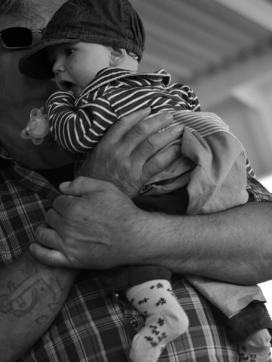 a man holding a baby in his arms