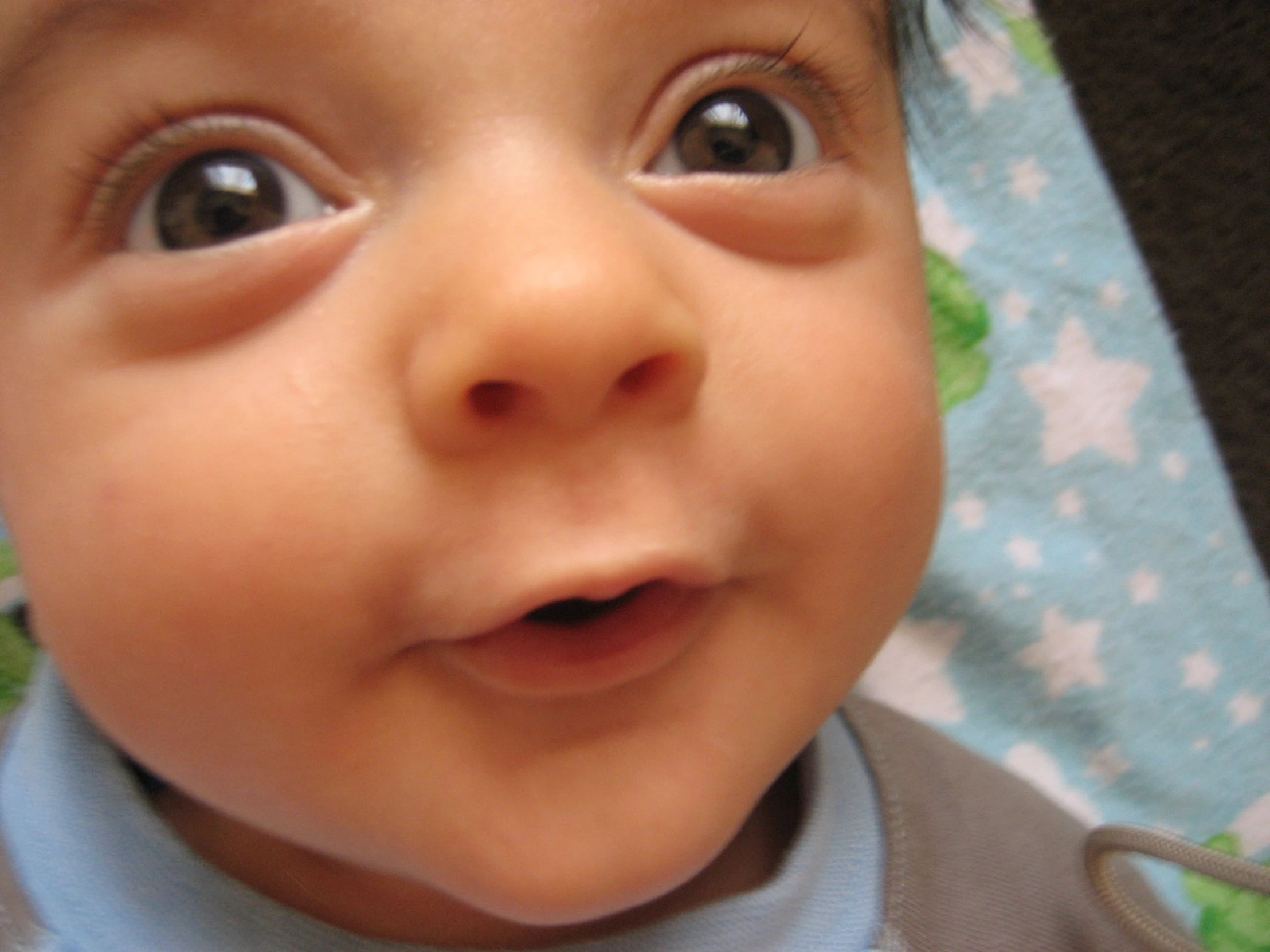 an adorable baby boy wearing blue is smiling