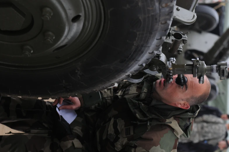 a man with a gun wearing sunglasses on his nose