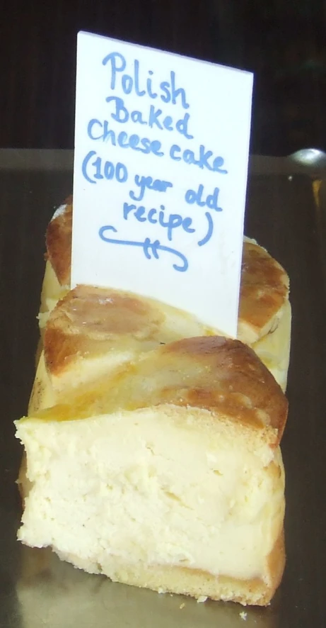 a piece of cheese cake sitting on top of a silver tray