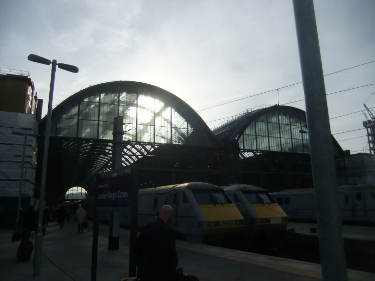 the sun is shining brightly above the train depot