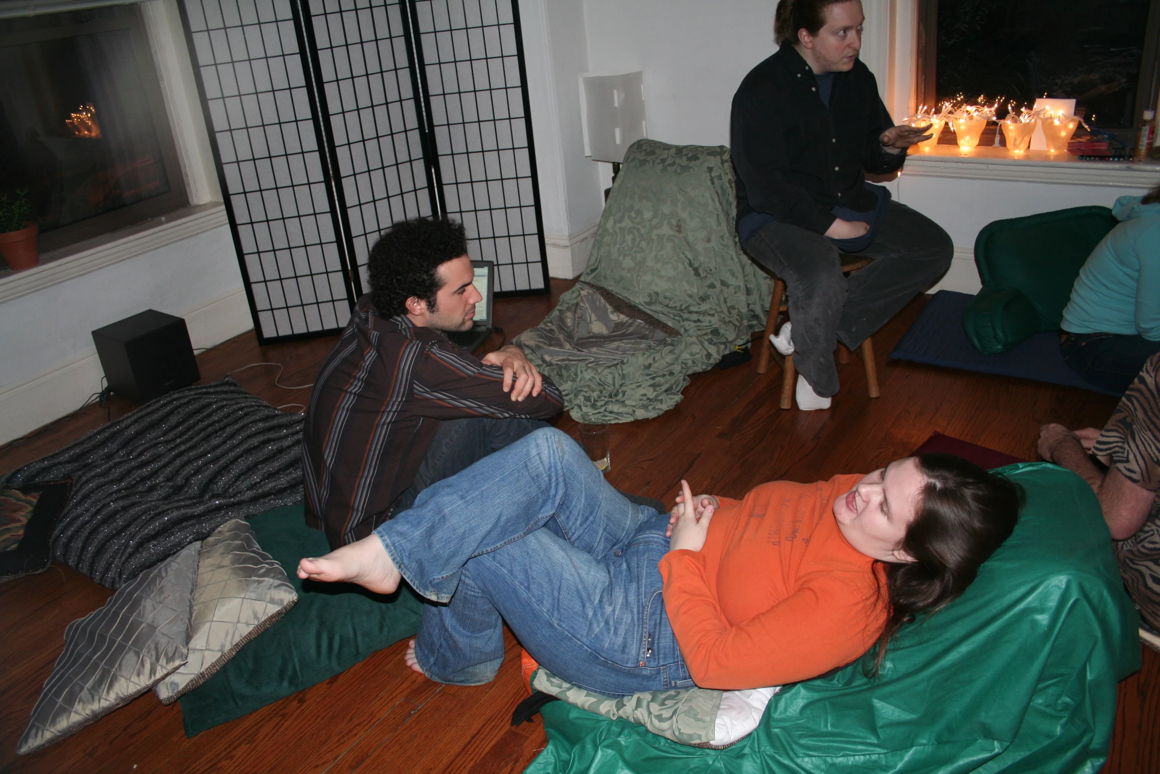 people in living room sitting on various sofas, one is happy