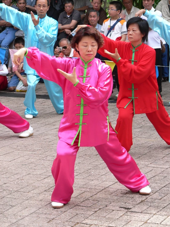 two people with one on the side doing a taido move