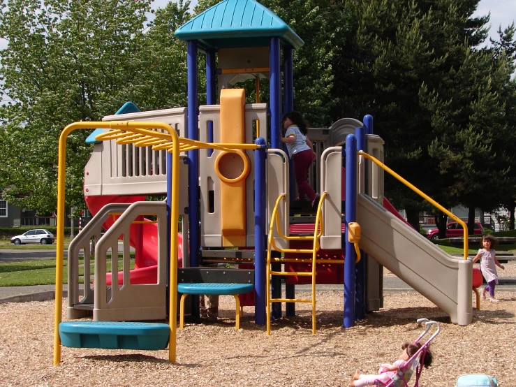 children playing at a playground in a park