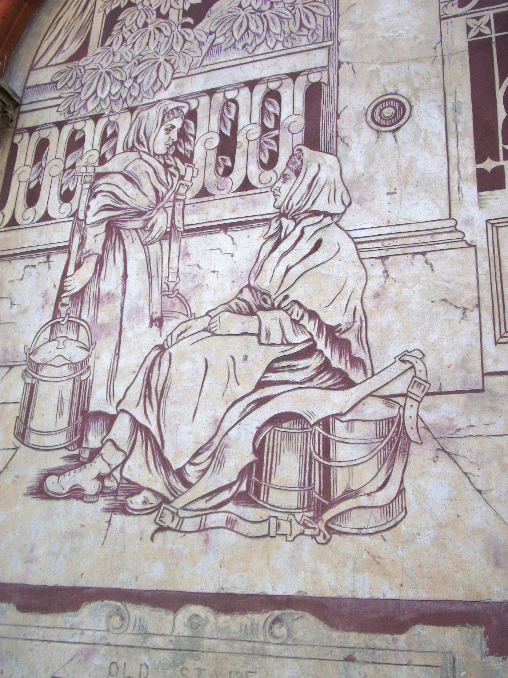 a mosaic image of a woman sitting on a bench
