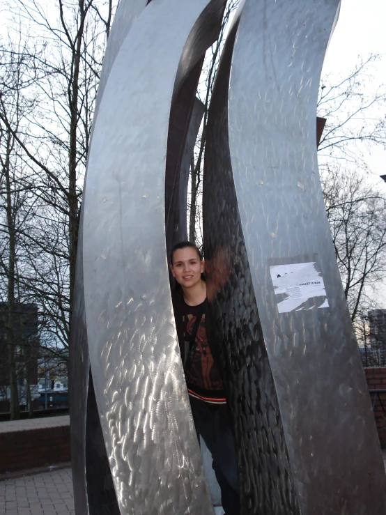 a man standing behind metal numbers on a public area