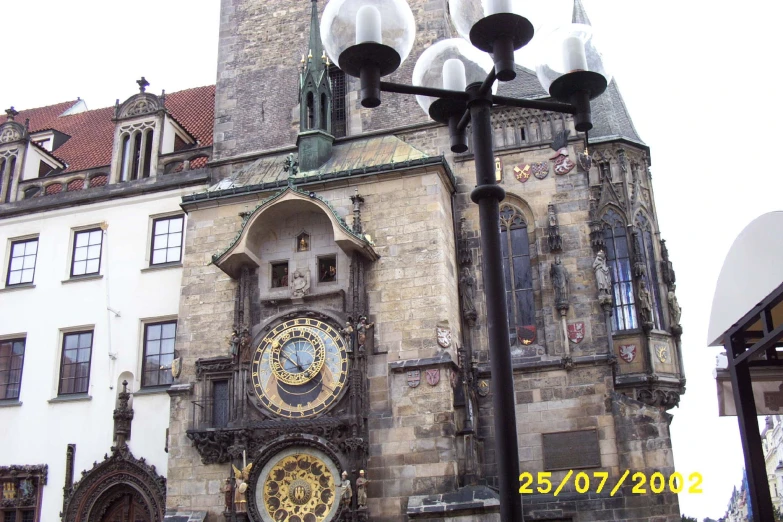 a street light sitting in front of an old building