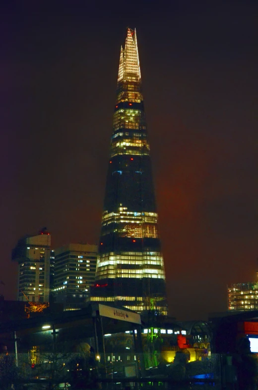 the shardling tower, london by night, is lit up in the light