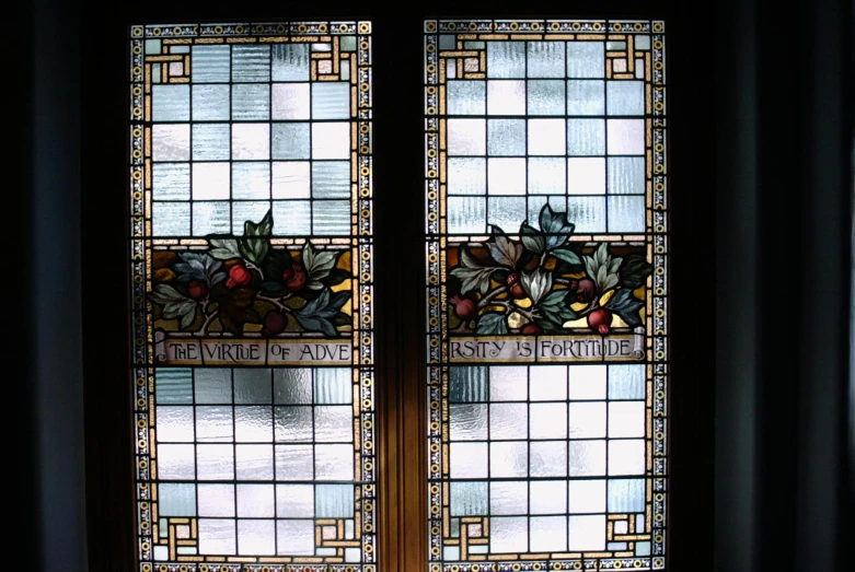 two stained glass doors on a black wall