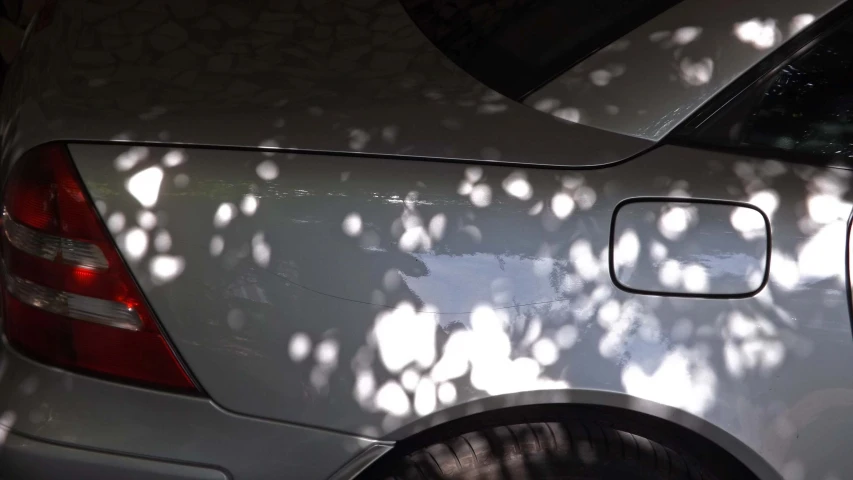 the shadow of sunlight cast on a car's side