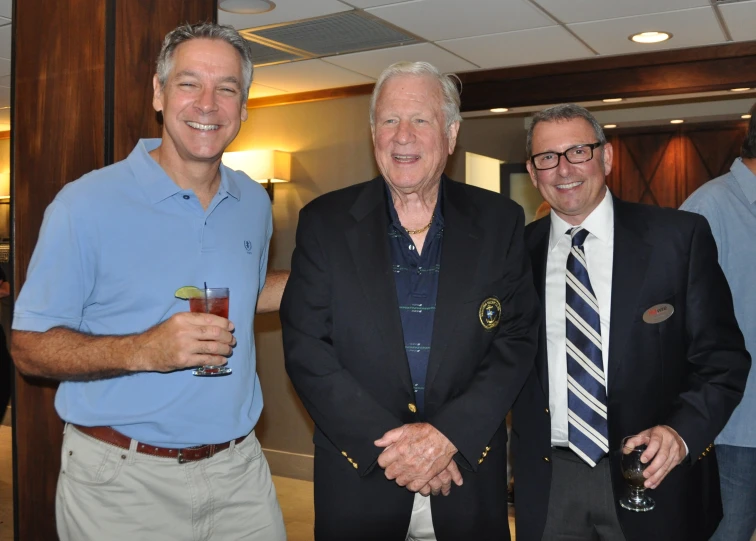 a group of three men standing next to each other