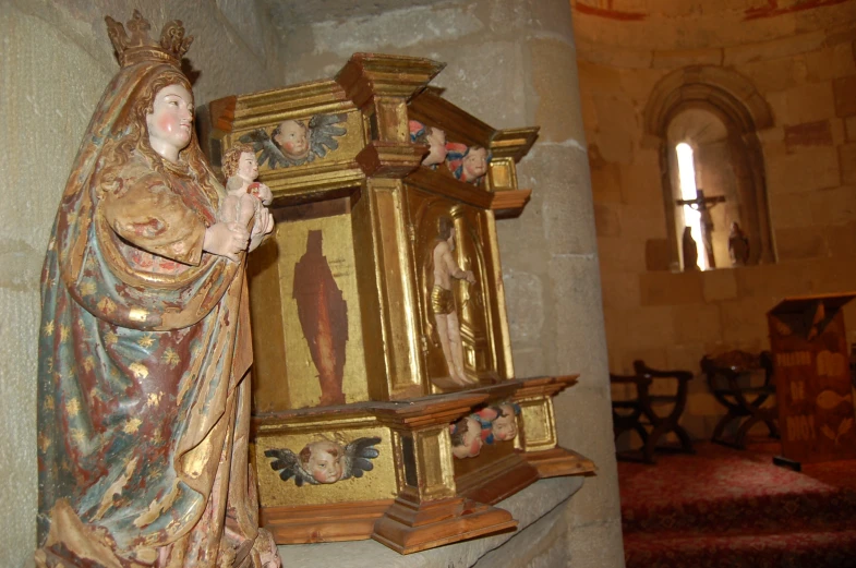 a statue with statues around it inside of a church